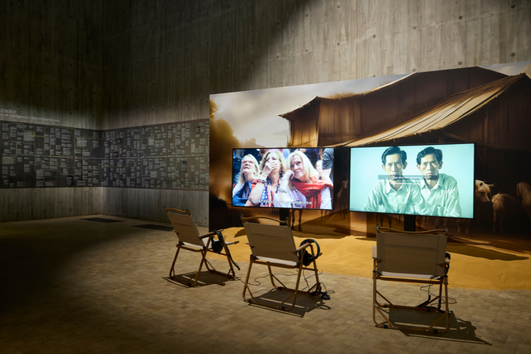 'Figures of History and The Grounds of Intelligence' 2024. Lecture and video installation with live AI-generated images, wallpaper and sand, 74’. Installation view, Sigg Prize 2025, M+, Hong Kong, 2025. Courtesy of M+, Hong Kong. Photo: Lok Cheng